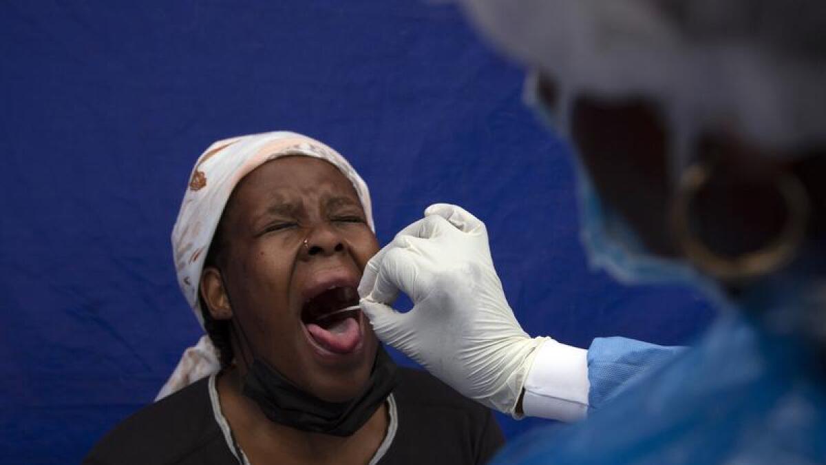 A throat swab is taken to test for COVID-19 at a facility in Soweto.