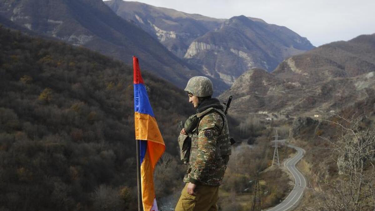 An Armenian soldier stands guard near the border with Azerbaijan.