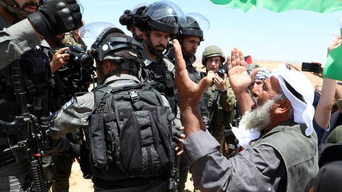 Palestinian protesters confront Israeli soldiers in the West Bank