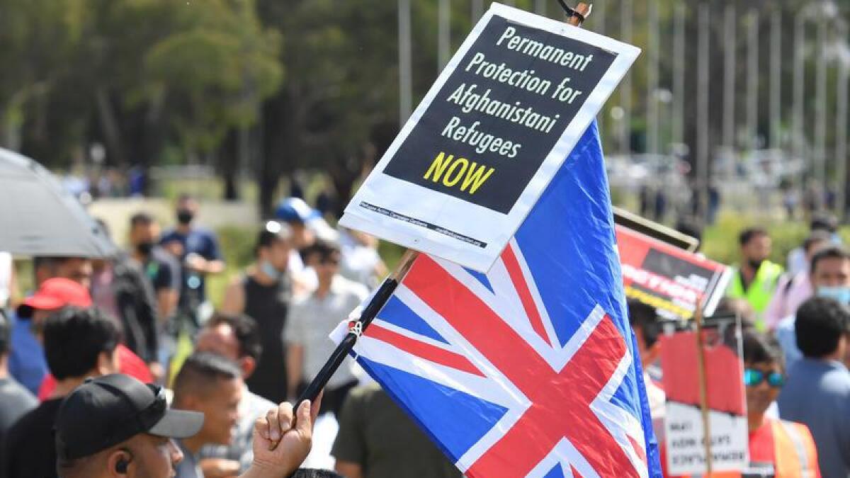 Hundreds of Afghan asylum seekers rally outside Parliament House.
