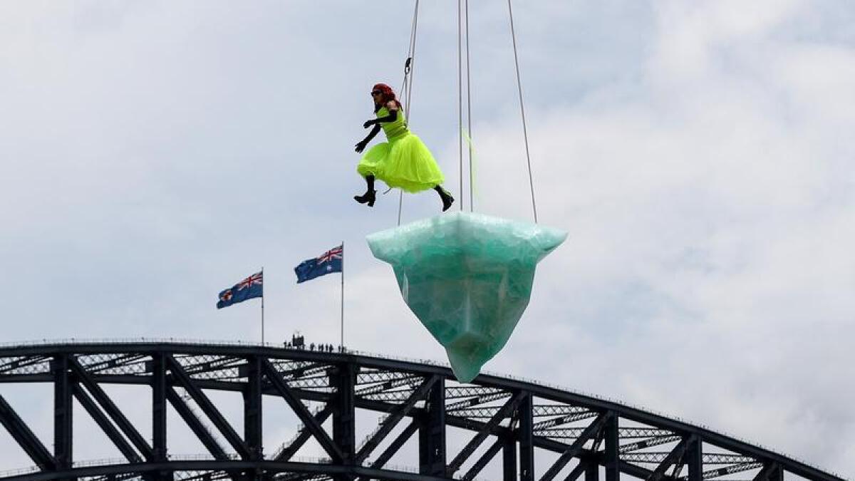 Vicki Van Hout performs on an iceberg suspended above Sydney Harbour.