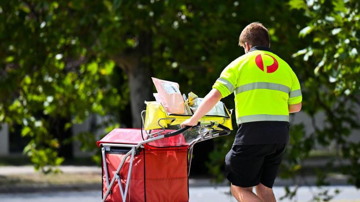 Mail is delivered by an Australia Post employee