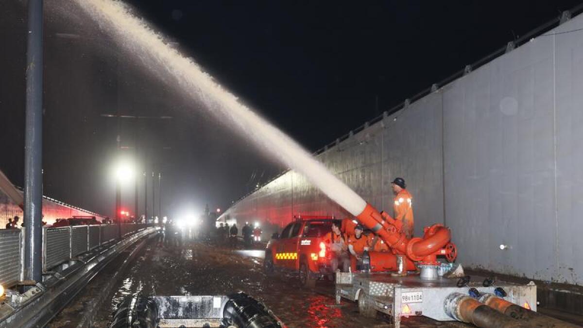 Workers pump water out of a flooded tunnel in central South Korea