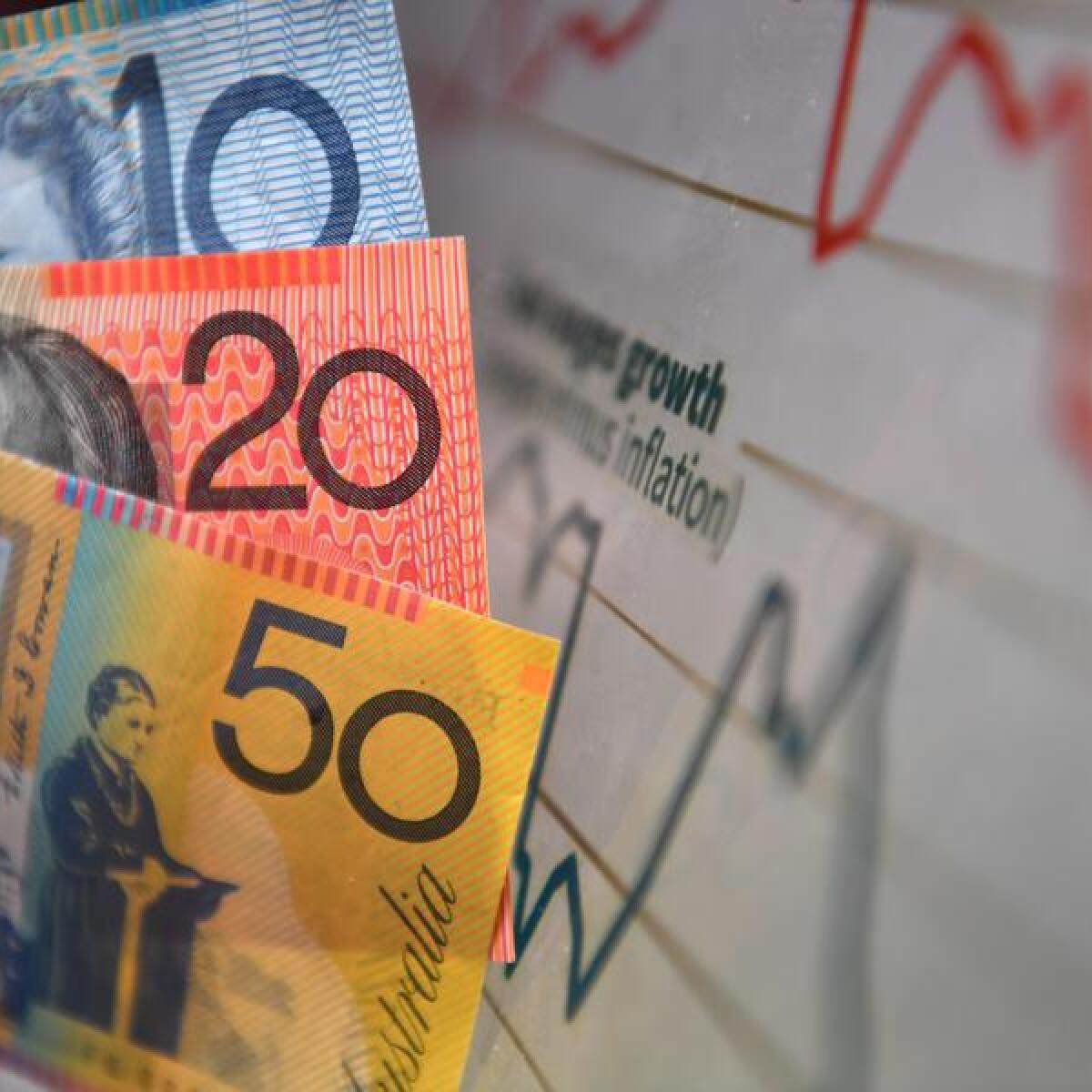 Australian currency is seen next to a wages graph in Brisbane