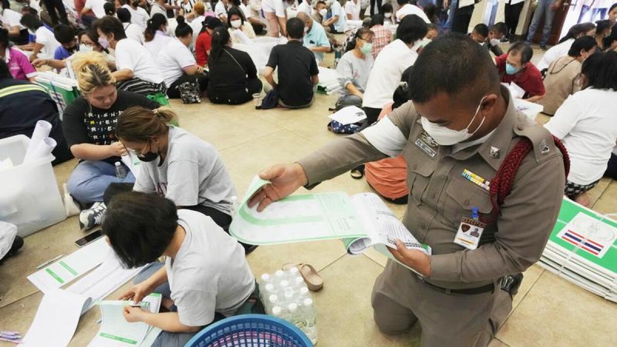 People prepare ballots for voting in Thailand