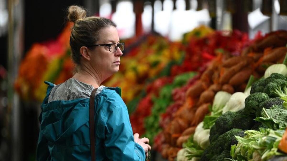Woman shops for produce.