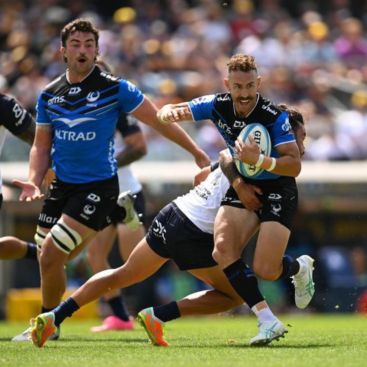 Nic White (right) runs with the ball for the Western Force. 