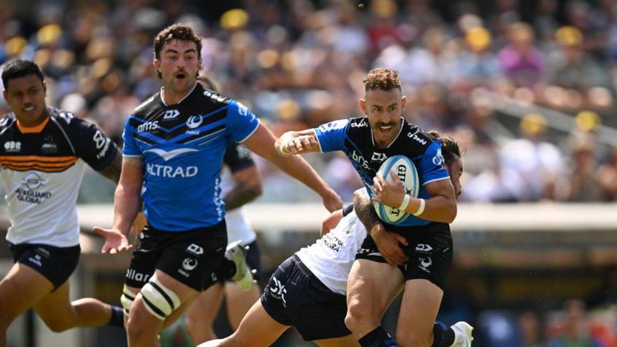Nic White (right) runs with the ball for the Western Force. 