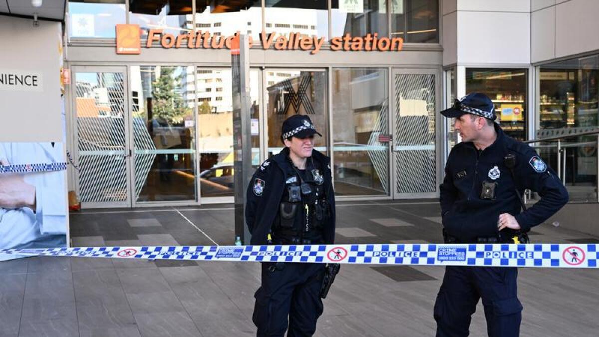Police are seen outside the Fortitude Valley train station.