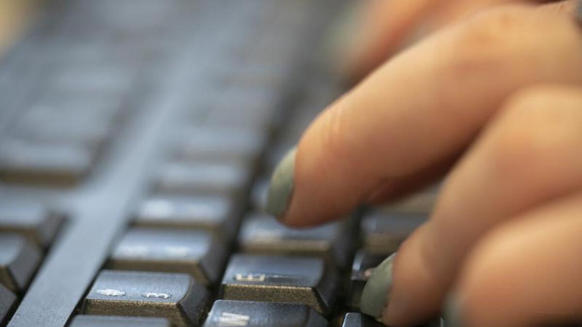 A woman types on a keyboard in New York