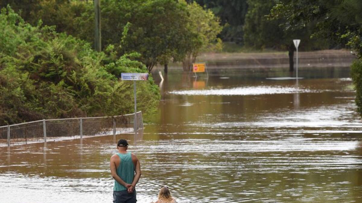 People look at floodwaters in Lismore in March 2022.