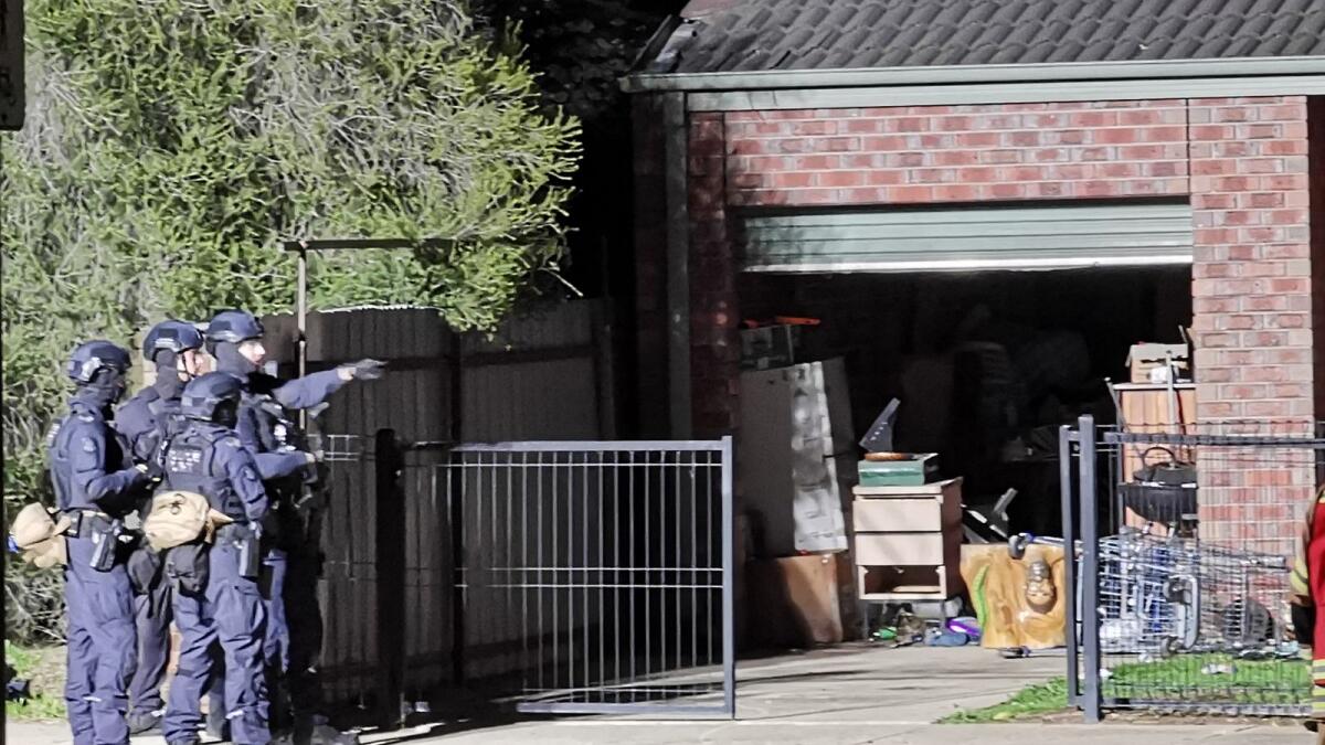 Police on the scene of a siege earlier on Monday afternoon. Picture: Monique Preston.