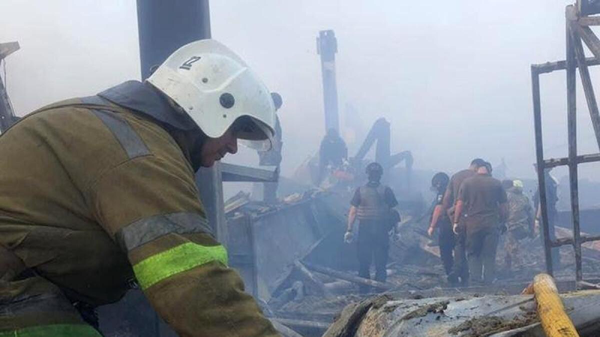 Firefighters at a shopping centre in Kremenchuk, Ukraine