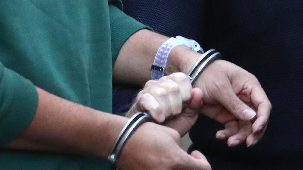 A prisoner in handcuffs.