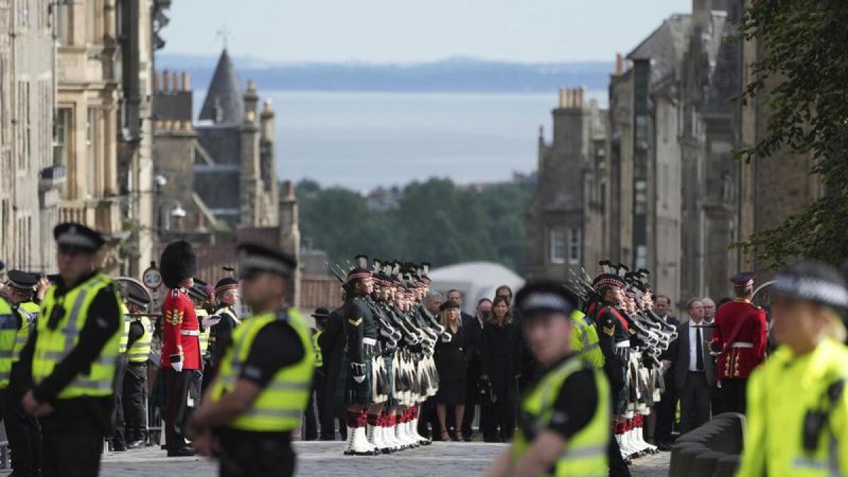 Police line the route of a royal procession in Edinburgh.
