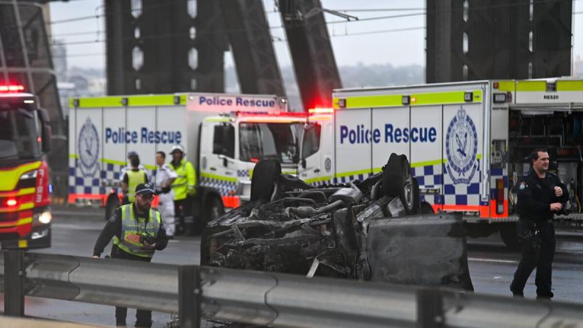 Police at the scene of the multi-vehicle crash and fire.