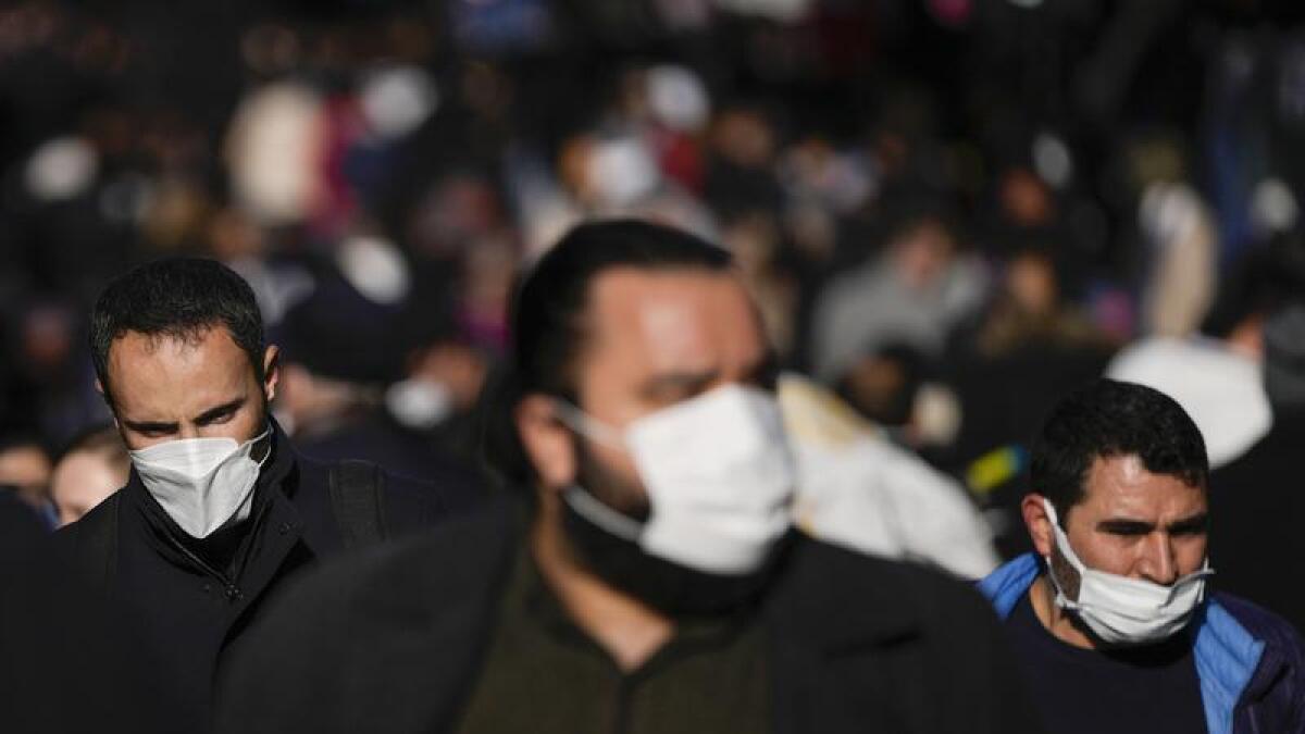 Pedestrians wearing face masks.