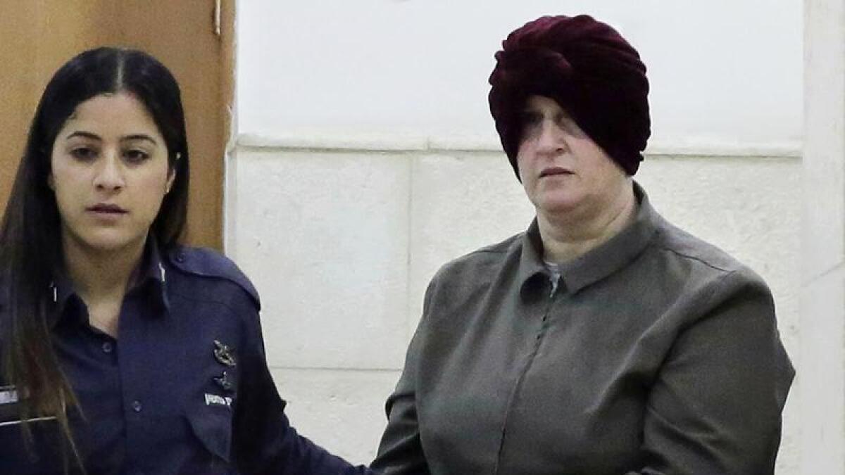 Malka Leifer, right, is brought to a courtroom in Jerusalem