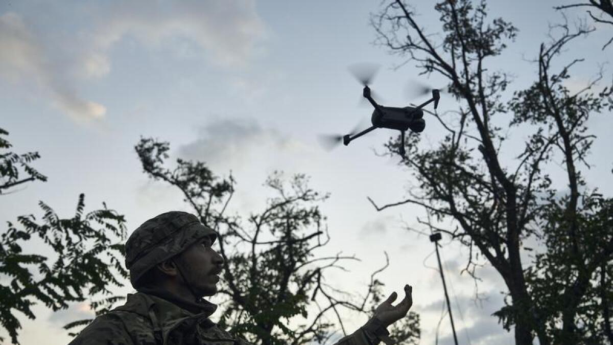 A Ukrainian soldier launches a drone
