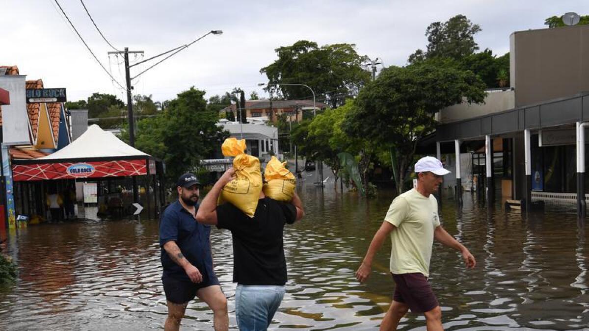 People carrying sand bags during the floods in Brisbane (file image)
