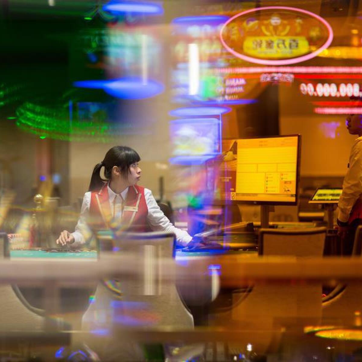 A dealer sits at a blackjack table at a Macau casino.