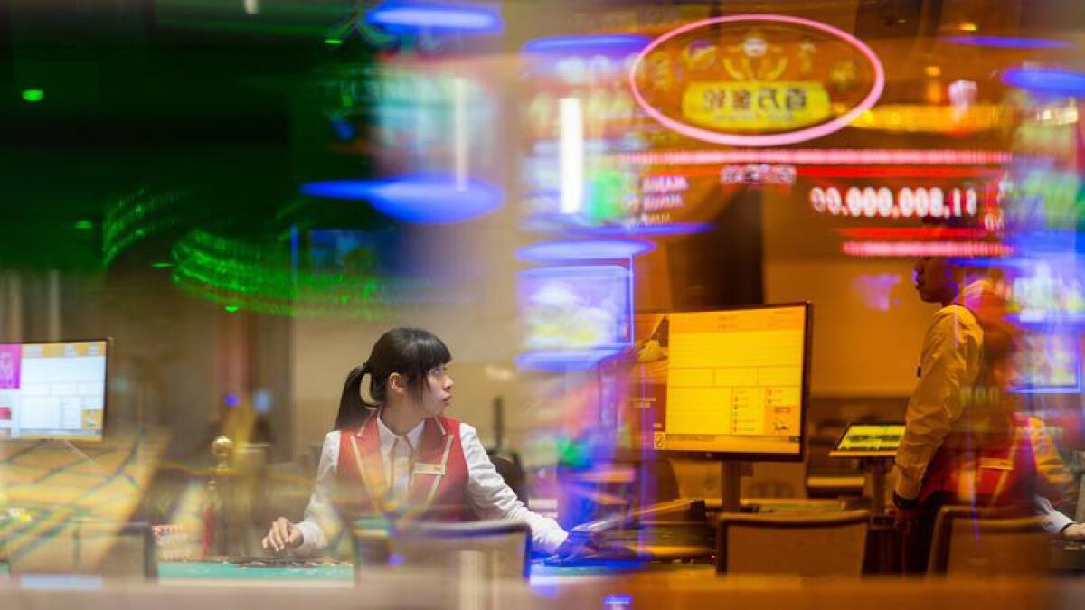 A dealer sits at a blackjack table at a Macau casino.