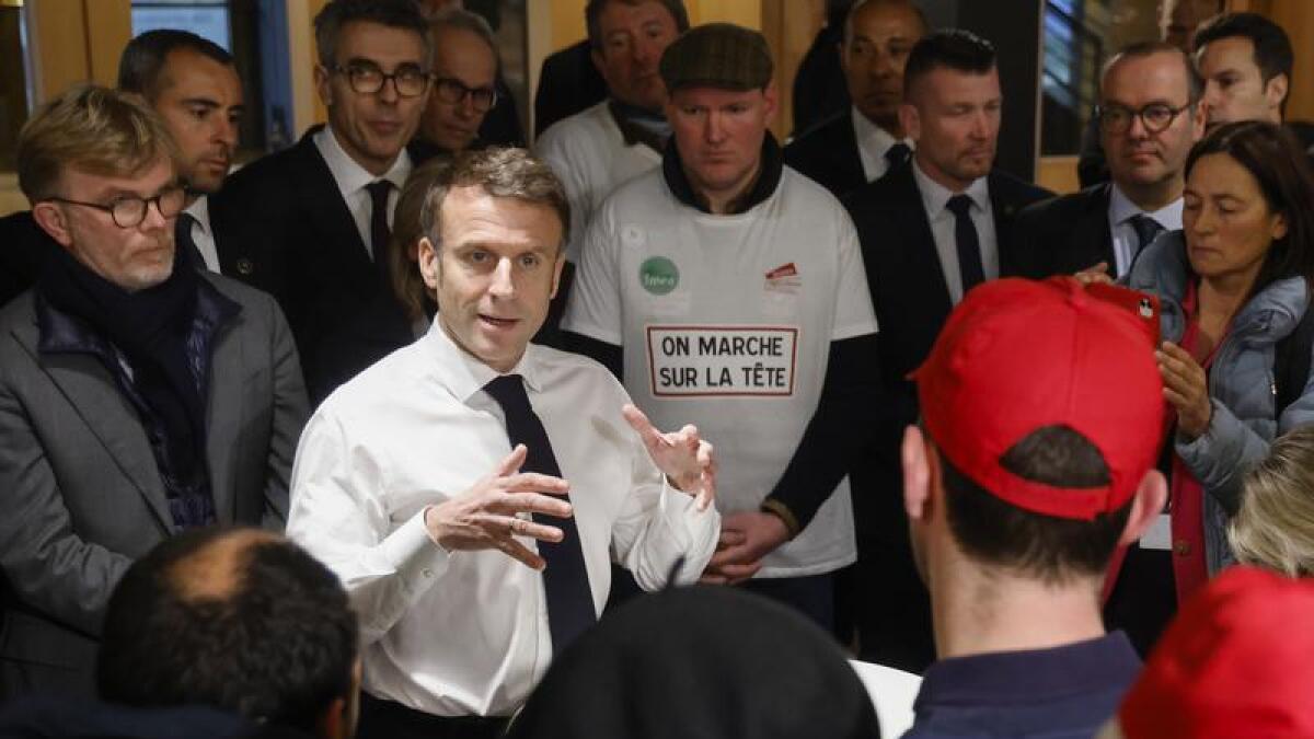 French President Emmanuel Macron in a discussion with farmers