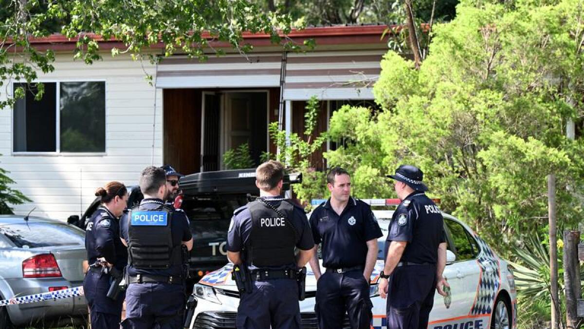 Police outside the home where two bodies were found.