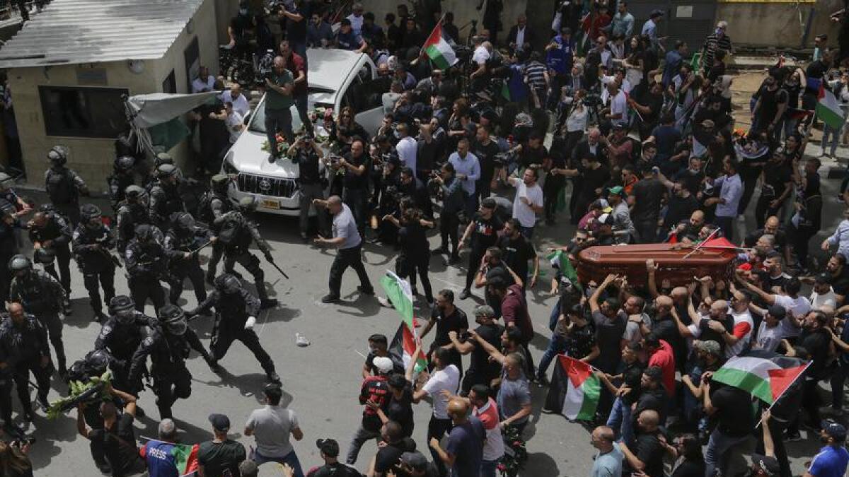 Israeli police confront mourners
