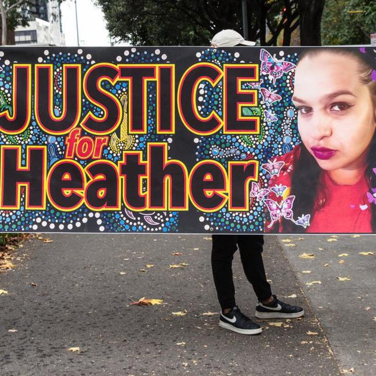 Heather Calgaret's supporters outside court with a banner