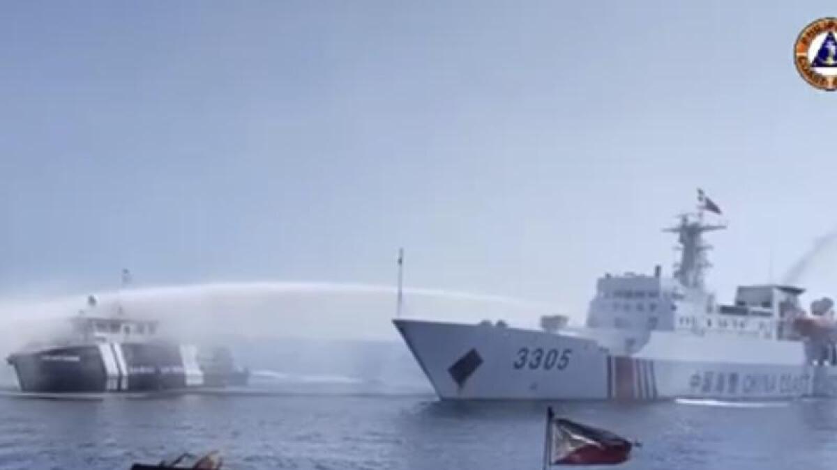 A Chinese ship uses a water cannon on a Philippines vessel