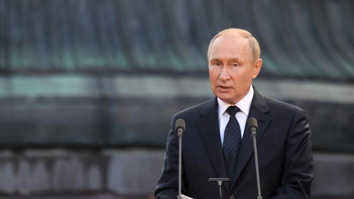 A man at a microphone (Putin)