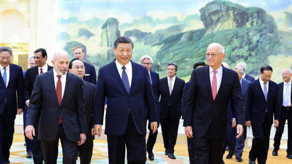 Chinese President Xi Jinping walks with US business representatives