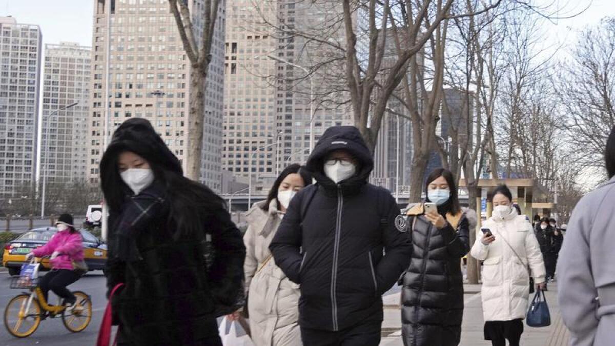 Commuters wearing masks in Beijing.