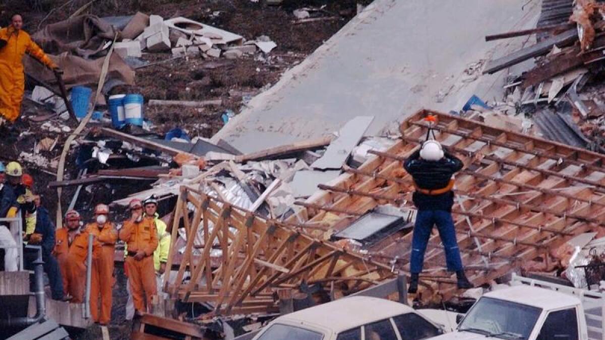 Police and rescuers search through rubble from the Thredbo landslide