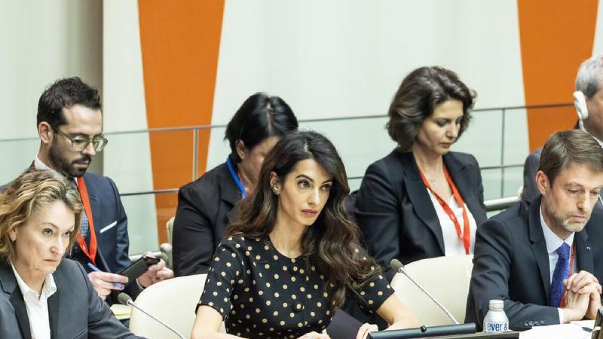 Human rights lawyer Amal Clooney (c).