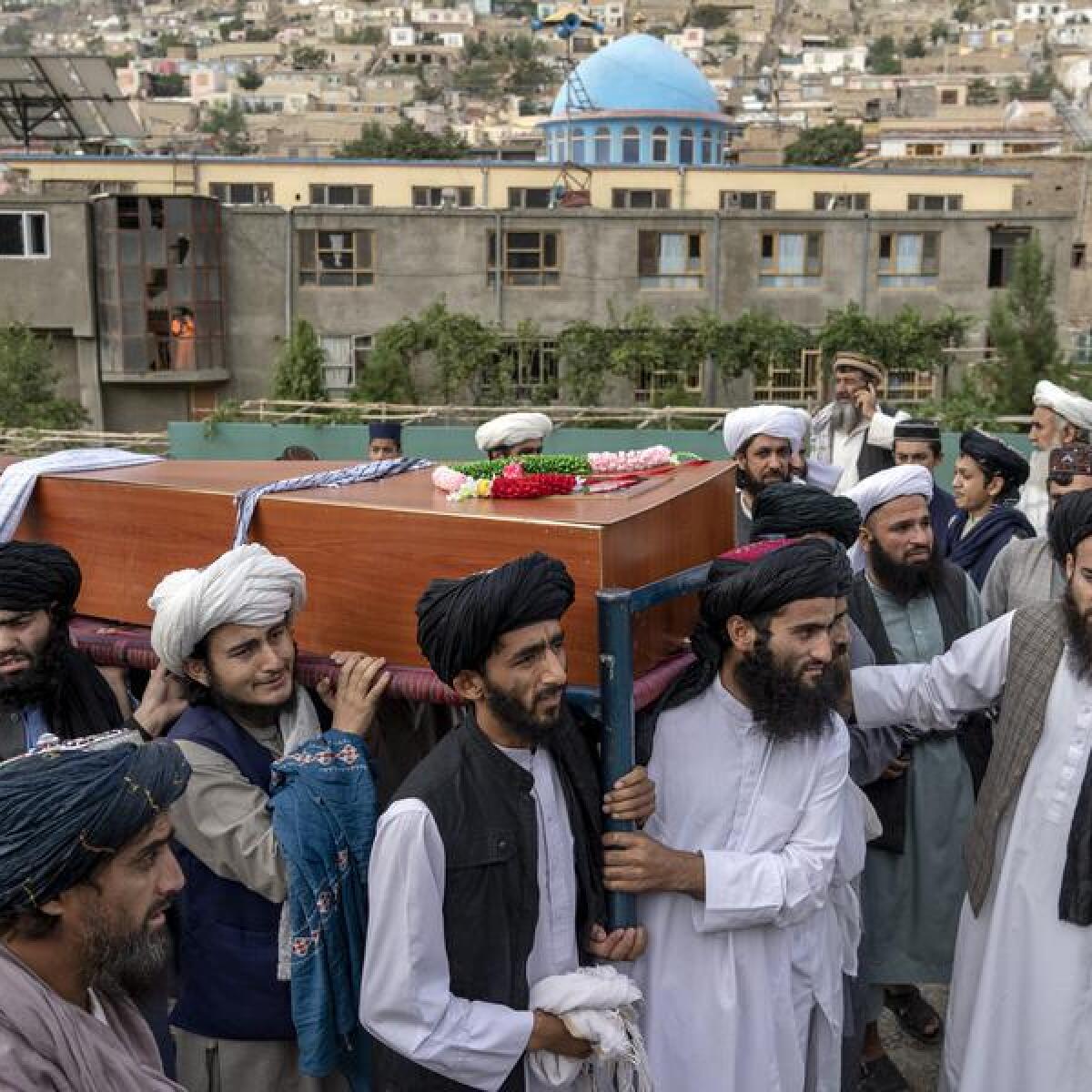 Mourners carry a victim of the Kabul bombing