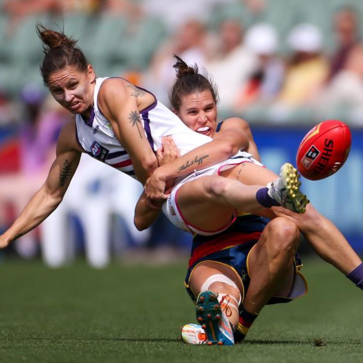 Kiara Bowers of the Dockers is tackled.