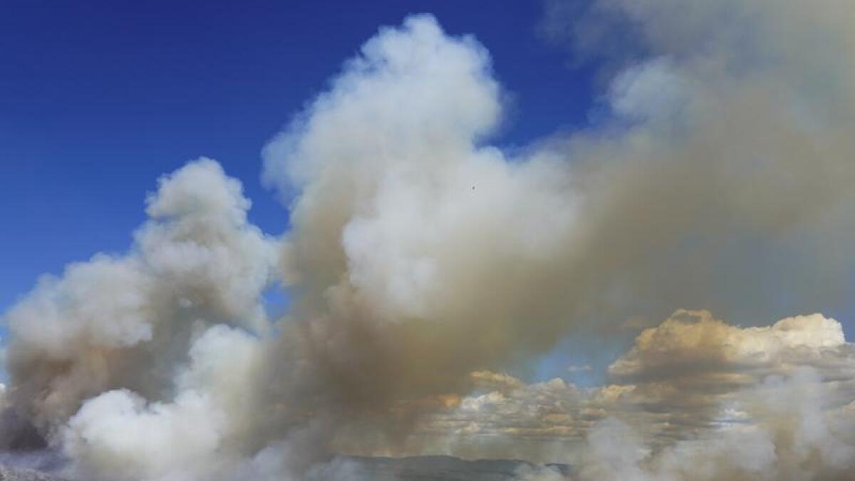 Clouds of smoke rise during a wildfire near Alcublas, eastern Spain,