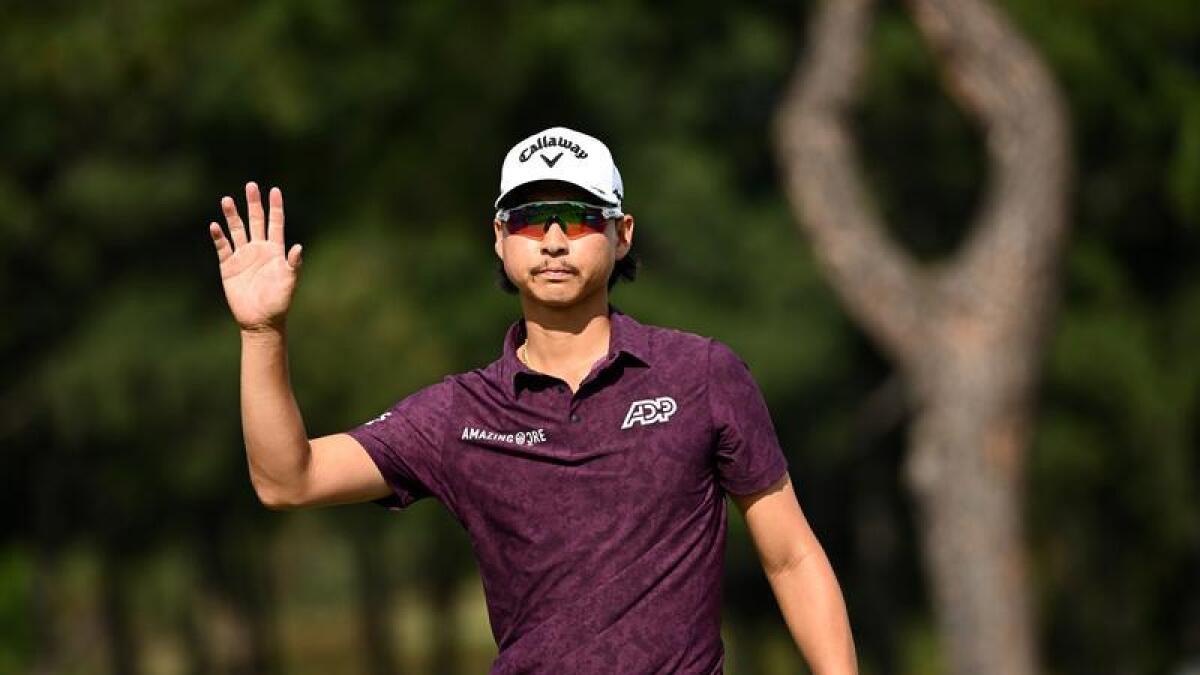 Min Woo Lee waves to the crowd after his second round at the Open.