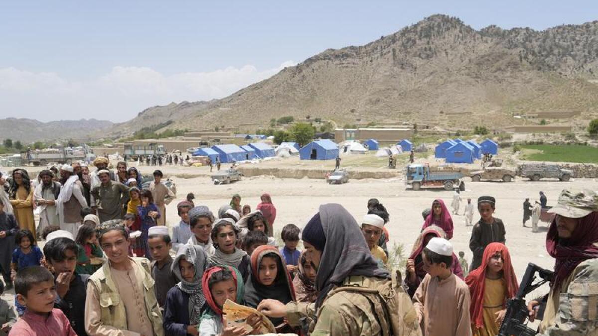 Afghan quake survivors receive aid at a camp.