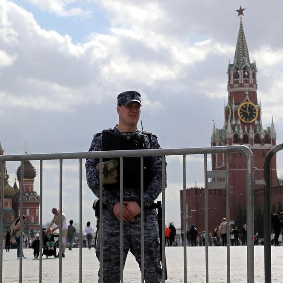 Russian policeman stands guard at the Red Square outside the Kremlin