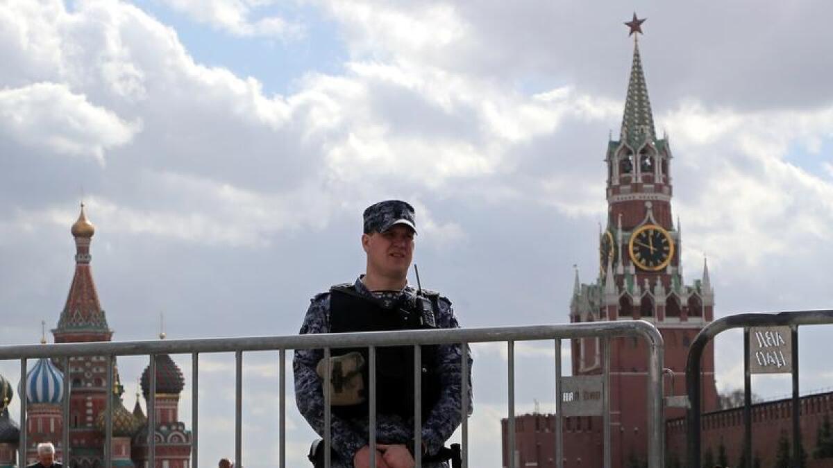 Russian policeman stands guard at the Red Square outside the Kremlin
