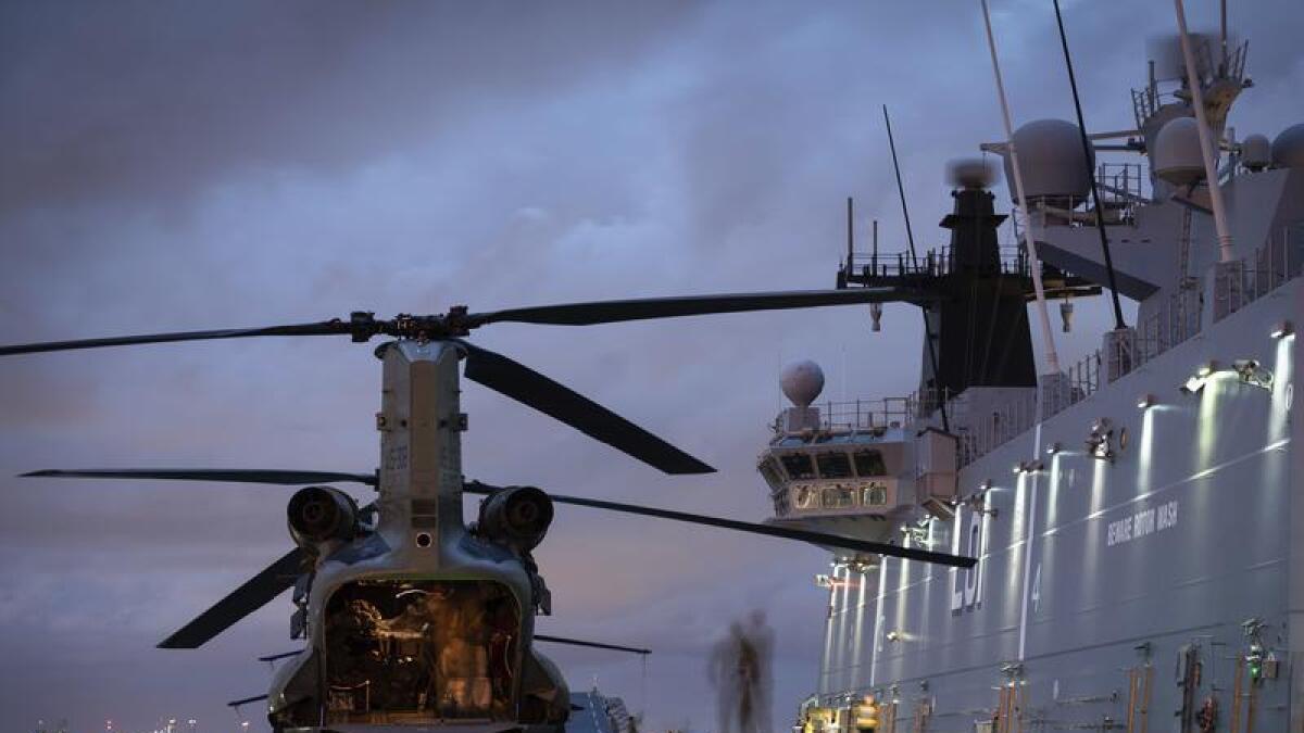 An ADF helicopter on HMAS Adelaide in Brisbane