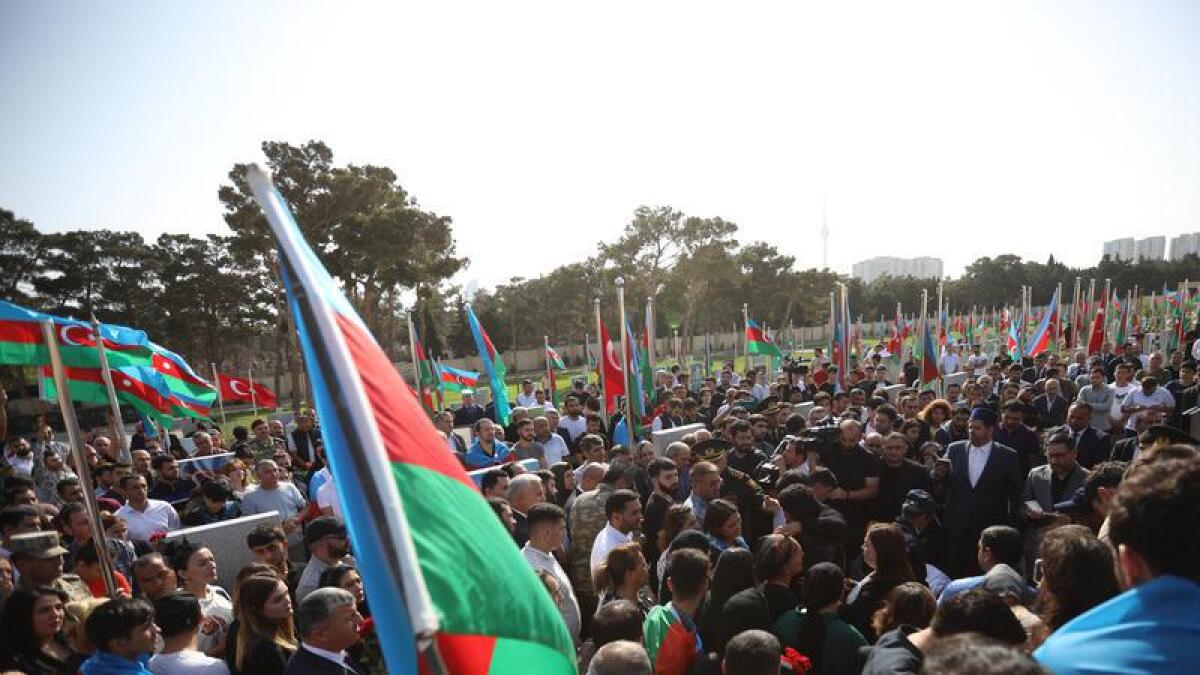 Azeri people gather for mass funerals of troops